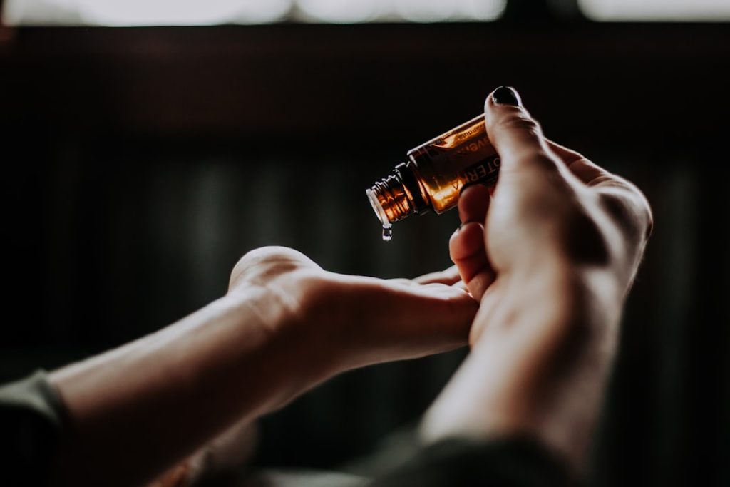 person-holding-amber-glass-bottle-0mof-fe0w0a healing hands